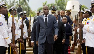 In this April 7, 2018, file photo, Haiti&#39;s President Jovenel Moise, center, leaves the museum during a ceremony marking the 215th anniversary of revolutionary hero Toussaint Louverture&#39;s death, at the National Pantheon museum in Port-au-Prince, Haiti. Moïse was assassinated after a group of unidentified people attacked his private residence, the country’s interim prime minister said in a statement Wednesday, July 7, 2021. (AP Photo/Dieu Nalio Chery, File)