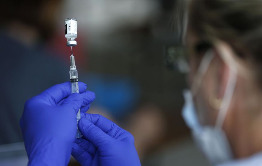 In this June 22, 2021, file photo, nurse Jody Berry draws a syringe full of the Johnson & Johnson COVID-19 vaccine at a clinic at Mother's Brewing Company in Springfield, Mo. New York threw a ticker-tape parade Wednesday, July 7, for the health care workers and others who helped the city get through the darkest days of COVID-19, while authorities in Missouri struggled to beat back a surge blamed on the fast-spreading delta variant and deep resistance to getting vaccinated. (Nathan Papes/The Springfield News-Leader via AP) ** FILE **