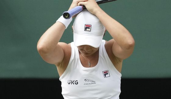 Australia&#39;s Ashleigh Barty celebrates after defeating Germany&#39;s Angelique Kerber in the women&#39;s singles semifinals match on day ten of the Wimbledon Tennis Championships in London, Thursday, July 8, 2021. (AP Photo/Alberto Pezzali)