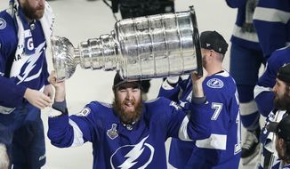 Tampa Bay Lightning defenseman David Savard hoists the Stanley Cup after the series win in Game 5 of the NHL hockey Stanley Cup finals against the Montreal Canadiens, Wednesday, July 7, 2021, in Tampa, Fla. (AP Photo/Gerry Broome) **FILE**