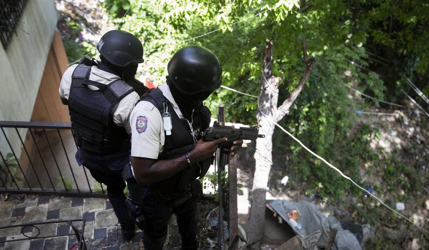 Police search the Morne Calvaire district of Petion Ville for suspects who remain at large in the murder of Haitian President Jovenel Moise in Port-au-Prince, Haiti, Friday, July 9, 2021. Moise was assassinated on July 7 after armed men attacked his private residence and gravely wounded his wife, first lady Martine Moise. (AP Photo/Joseph Odelyn)