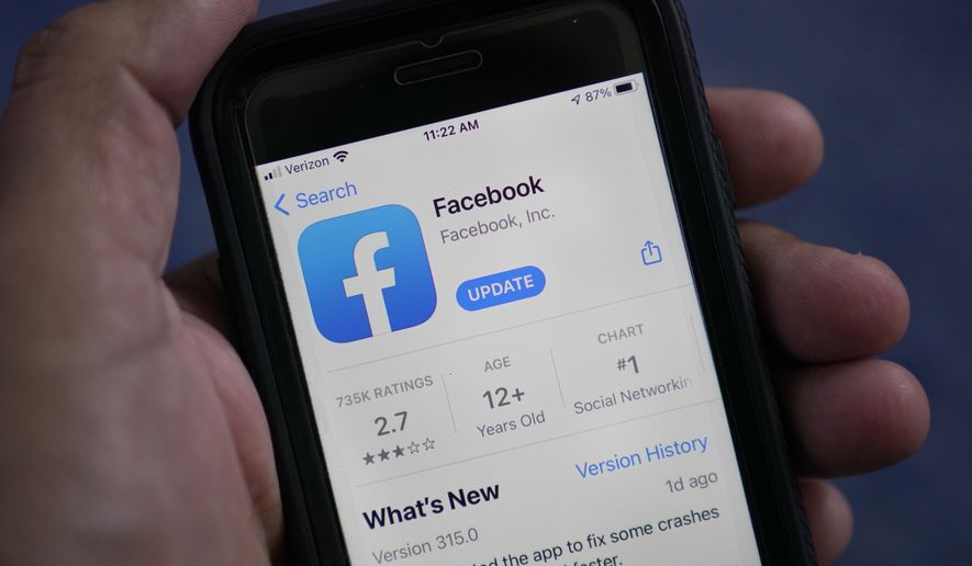 The Facebook app is shown on a smartphone, Friday, April 23, 2021, in Surfside, Fla. (AP Photo/Wilfredo Lee) ** FILE **