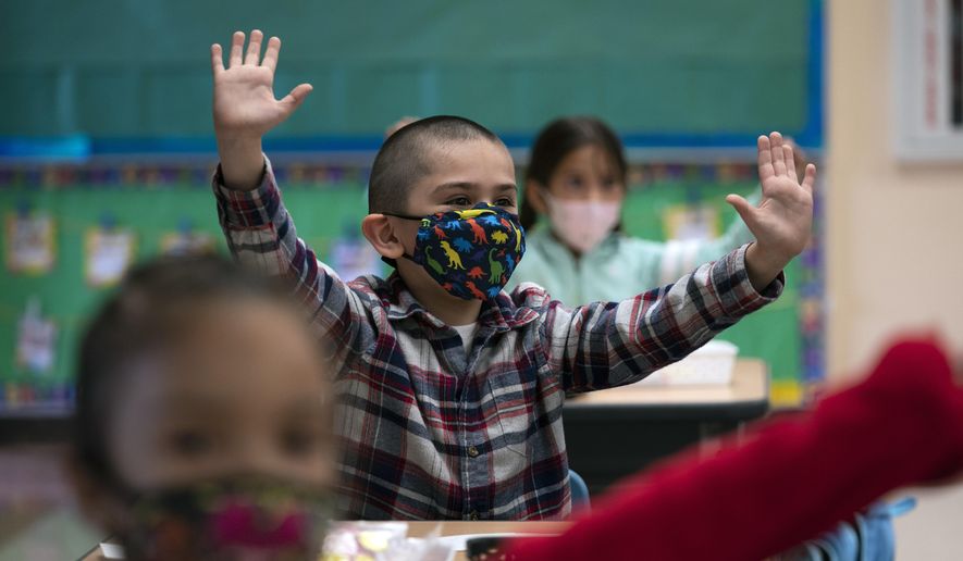 FILE - In this April 13, 2021, file photo, kindergarten students participate in a classroom activity on the first day of in-person learning at Maurice Sendak Elementary School in Los Angeles. California will require that masks be worn at schools when classrooms open this fall. California Health and Human Services Secretary Dr. Mark Ghaly said, Friday July 9, 2021, that not all schools can accommodate physical distancing of at least 3-feet or more, so the best preventative measure is indoor masking. (AP Photo/Jae C. Hong, File)