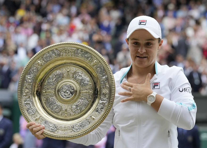 Australia&#39;s Ashleigh Barty poses with the trophy for the media after winning the women&#39;s singles final, defeating the Czech Republic&#39;s Karolina Pliskova on day twelve of the Wimbledon Tennis Championships in London, Saturday, July 10, 2021. (AP Photo/Kirsty Wigglesworth)