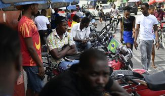 Mototaxi drivers wait for customers in Port-au-Prince, Haiti, Saturday, July 10, 2021, three days after President Jovenel Moise was assassinated in his home. (AP Photo/Matias Delacroix)