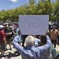 In this May 25, 2021, file photo, a man holds up a sign against Critical Race Theory during a protest outside a Washoe County School District board meeting in Reno, Nev. (Andy Barron/Reno Gazette-Journal via AP, File)  **FILE**