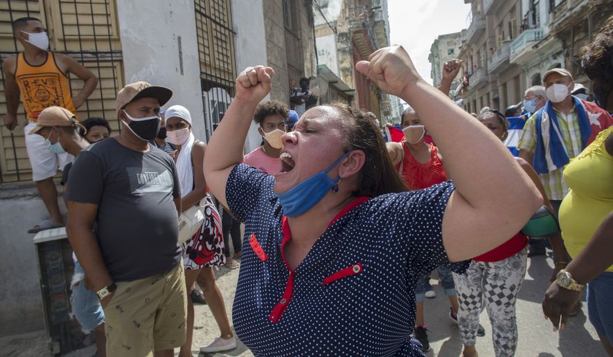 A woman shouts during a an anti-government protest in Havana, Cuba, Sunday, July 11, 2021. (AP Photo/Ismael Francisco)