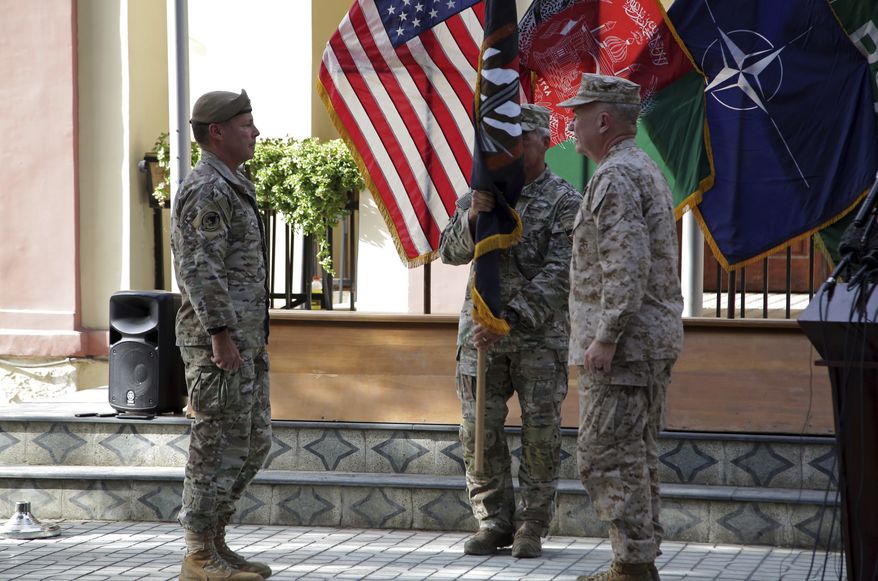 U.S. Army Gen. Scott Miller, the top U.S. commander in Afghanistan, left, hands over his command to Marine Gen. Frank McKenzie, the head of U.S. Central Command, right, at a ceremony at Resolute Support headquarters, in Kabul, Afghanistan, Monday, July 12, 2021. The United States is a step closer to ending a 20-year military presence that became known as its &quot;forever war,&quot; as Taliban insurgents continue to gain territory across the country. (AP Photo/Ahmad Seir)