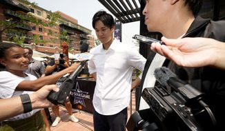 Shohei Ohtani, of the Los Angeles Angeles, larrives to a news conference to be named the American League&#39;s starting pitcher for the MLB All-Star baseball game, Monday, July 12, 2021, in Denver. (AP Photo/David Zalubowski)