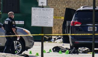 Body armor is seen near a minivan in a parking lot area of a mall where two officers on the U.S. Marshals&#39; task force where allegedly shot in Baltimore, according to officials, Tuesday, July 13, 2021. The Marshal&#39;s wounds aren&#39;t thought to be life-threatening. (AP Photo/Julio Cortez)