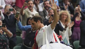 Switzerland&#39;s Roger Federer leaves the court after being defeated by Poland&#39;s Hubert Hurkacz during the men&#39;s singles quarterfinals match on day nine of the Wimbledon Tennis Championships in London, Wednesday, July 7, 2021. (AP Photo/Alberto Pezzali)