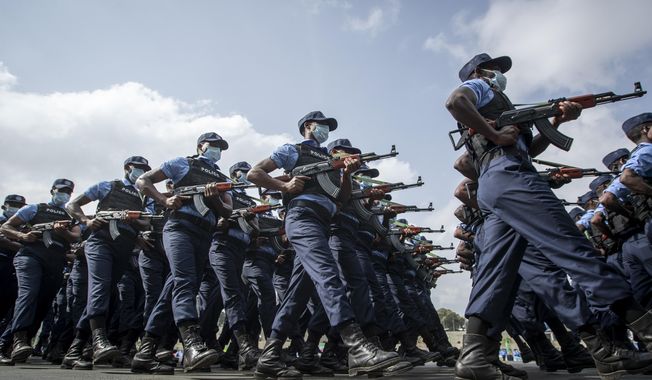 In this Saturday, June 19, 2021, file photo, police march during a parade to display new police uniforms and instruct them to maintain impartiality and respect the law during the general election, in Meskel Square in downtown Addis Ababa, Ethiopia. Witnesses say thousands of Tigrayans are being detained by police and their businesses closed in a new wave of ethnic targeting by Ethiopian authorities over the eight-month conflict in the Tigray region. (AP Photo/Ben Curtis, File)