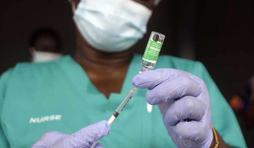 In this Friday, March 12, 2021, file photo, a nurse prepares one of the country&#39;s first coronavirus vaccinations, using the AstraZeneca vaccine manufactured by the Serum Institute of India and provided through the global COVAX initiative, at Yaba Mainland hospital in Lagos, Nigeria. (AP Photo/Sunday Alamba, File)