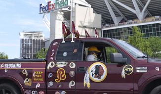 FILE - In this July 13, 2020, file photo, Rodney Johnson of Chesapeake, Va., sits in his truck outside FedEx Field in Landover, Md. Washington&#39;s NFL team will not be called the Warriors or have any other Native American imagery in the new name when it&#39;s revealed next year. (AP Photo/Susan Walsh, File)