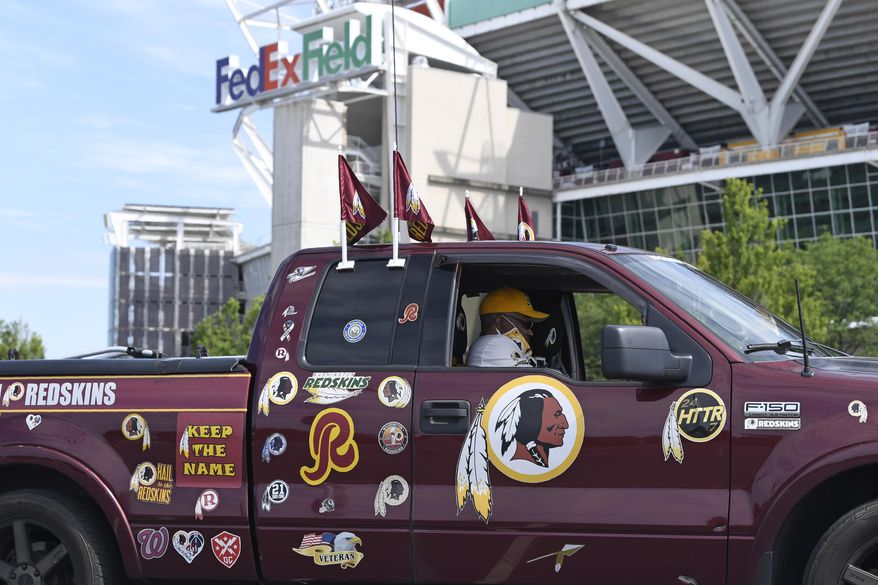 FILE - In this July 13, 2020, file photo, Rodney Johnson of Chesapeake, Va., sits in his truck outside FedEx Field in Landover, Md. Washington&#39;s NFL team will not be called the Warriors or have any other Native American imagery in the new name when it&#39;s revealed next year. (AP Photo/Susan Walsh, File)