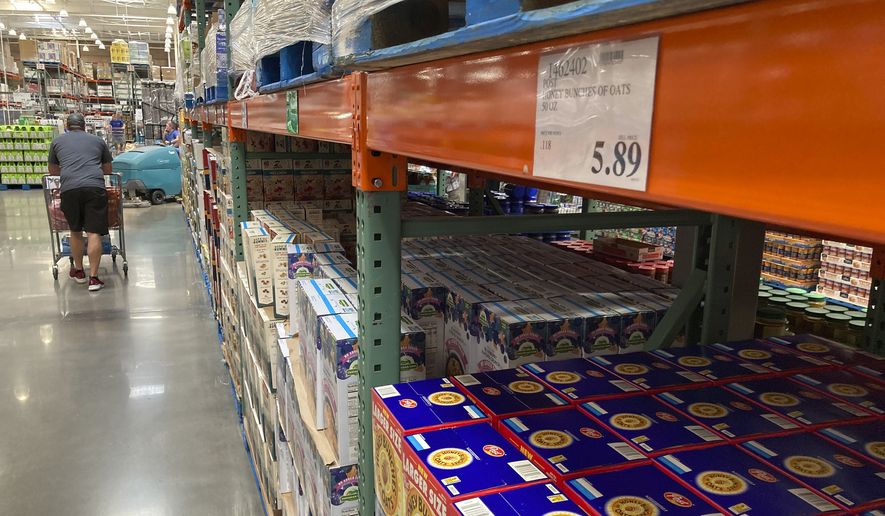 A shopper guides a cart past a line of gigantic boxes of breakfast cereals in a Costco warehouse on Thursday, June 17, 2021, in Lone Tree, Colo. (AP Photo/David Zalubowski) ** FILE **