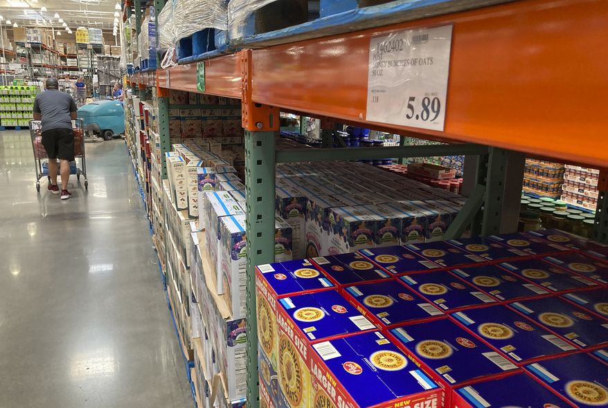 A shopper guides a cart past a line of gigantic boxes of breakfast cereals in a Costco warehouse on Thursday, June 17, 2021, in Lone Tree, Colo. (AP Photo/David Zalubowski) ** FILE **