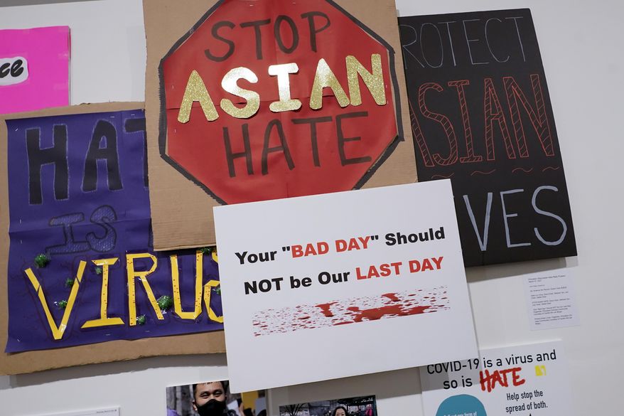In this file photo, signs used during anti Asian hate protests are seen on display during the press preview of 'Responses: Asian American Voices Resisting the Tides of Racism' at the Museum of Chinese in America, Wednesday, July 14, 2021, in New York. (AP Photo/Mary Altaffer) **FILE**