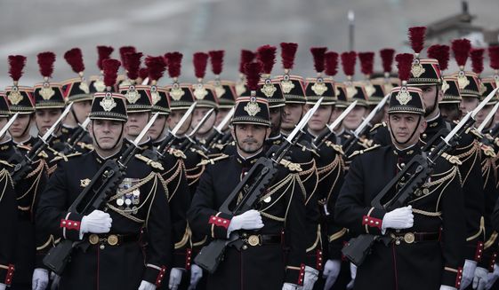 Members of the Republican Guard march in formation on the Champs Elysees prior to the Bastille Day parade in Paris, Wednesday July 14, 2021. Bastille Day is the French national holiday that commemorates the beginning of the French Revolution on July 14, 1789. (AP Photo/Lewis Joly)