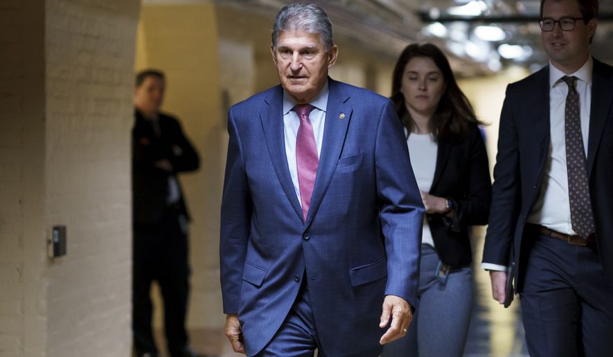 Sen. Joe Manchin III, D-W.Va., walks to meet with Democratic members of the Texas legislature to discuss voting rights after they left Austin trying to kill a Republican bill that would make it harder to vote in Texas, at the Capitol in Washington, Thursday, July 15, 2021. (AP Photo/J. Scott Applewhite)