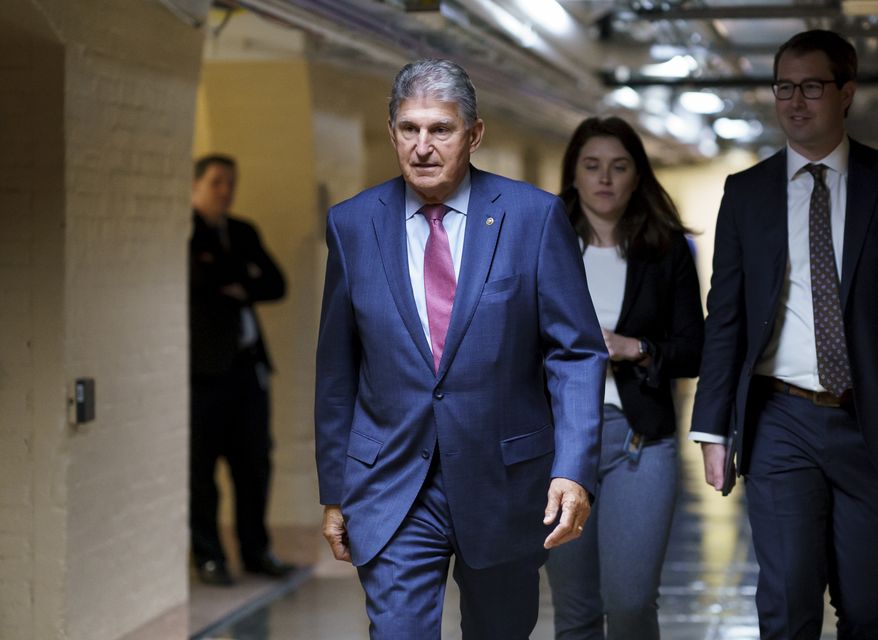 Sen. Joe Manchin III, D-W.Va., walks to meet with Democratic members of the Texas legislature to discuss voting rights after they left Austin trying to kill a Republican bill that would make it harder to vote in Texas, at the Capitol in Washington, Thursday, July 15, 2021. (AP Photo/J. Scott Applewhite)