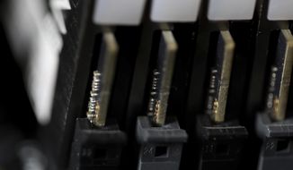 This Feb 23, 2019, photo shows the inside of a computer in Jersey City, N.J. The Biden administration will offer rewards up to $10 million for information leading to the identification of foreign state-sanctioned malicious cyber activity against critical U.S. infrastructure, including ransomware attacks. The administration is launching the website stopransomware.gov to offer the public resources for countering the threat. (AP Photo/Jenny Kane) ** FILE **