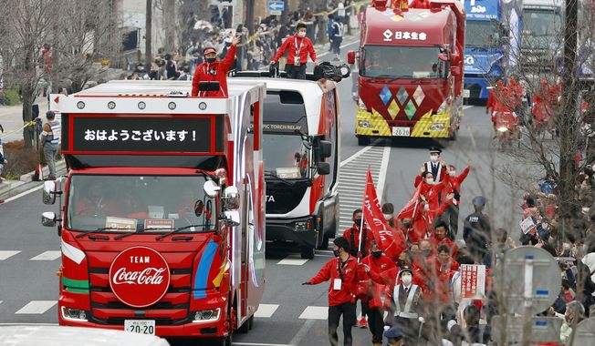 FILE - In this March 28, 2021, file photo, Olympic sponsors&#x27; vehicles parade ahead of torch relay in Ashikaga, Tochigi prefecture, north of Tokyo. The Olympic corporate sponsorship program has been a key part of the Olympic experience since it began in 1985. But all that magic from the Olympic sponsorship is being undermined because of the virus.  (Shinji Kita/Kyodo News via AP, File)