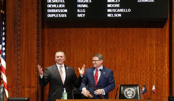 In this March 9, 2020, file photo, Louisiana House Speaker Clay Schexnayder, R-Gonzalez, left, and Senate President Page Cortez, R-Lafayette, react after Cortez broke Schexnayder&#39;s gavel for the opening of the 2020 general legislative session in Baton Rouge, La. Louisiana lawmakers will hold their first veto session under the state&#39;s nearly 50-year-old constitution. The session will open Tuesday, July 20, 2021, and last up to five days.  (AP Photo/Gerald Herbert, File)