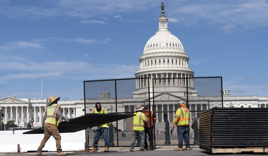 Workers remove the fence surrounding the U.S. Capitol building, six months after it was erected following the Jan. 6 riot at the Capitol, on Saturday, July 10, 2021, in Washington. (AP Photo/Jose Luis Magana)