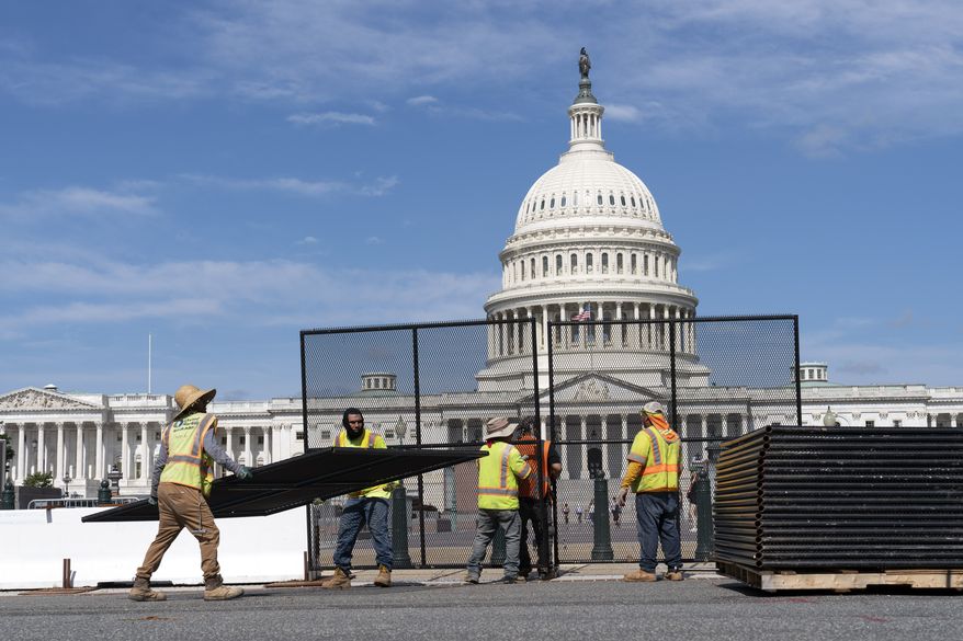 Workers remove the fence surrounding the U.S. Capitol building, six months after it was erected following the Jan. 6 riot at the Capitol, on Saturday, July 10, 2021, in Washington. (AP Photo/Jose Luis Magana)