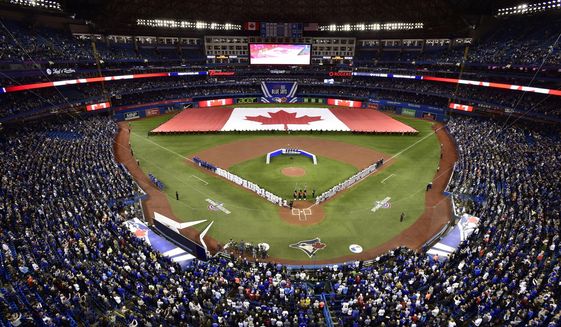 Members of the Toronto Blue Jays and the Detroit Tigers lineup before an opening day baseball game at Rogers Centre in Toronto, in this Thursday, March 28, 2019, file photo. Talks between the Toronto Blue Jays and the Canadian government have accelerated significantly and an exemption on border restrictions that would allow them to play in Canada starting July 30 may be possible, an official familiar with the talks told The Associated Press on Friday, July 16, 2021. (Frank Gunn/The Canadian Press via AP, File)
