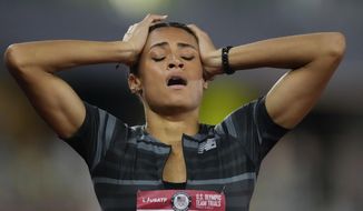 FILE - In this June 27, 2021, file photo, Sydney McLaughlin reacts after setting a new world record in the finals of the women&#39;s 400-meter hurdles at the U.S. Olympic Track and Field Trials in Eugene, Ore. The playbook for athletes provides a guide to a &amp;quot;safe and successful Games&amp;quot; for the Tokyo Olympics. It&#39;s filled with &amp;quot;cannots&amp;quot; and &amp;quot;do nots,&amp;quot; meaning a once-in-a-liftetime opportunity will be a whole lot less fun. (AP Photo/Ashley Landis, File)