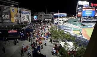 Spectators leave the stadium in the sixth inning of a baseball game between the Washington Nationals and the San Diego Padres, Saturday, July 17, 2021, in Washington. The game was suspended in the sixth inning after police said there was a shooting outside Nationals Park. (AP Photo/Nick Wass)