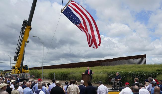 Former President Donald Trump, left, and Texas Gov. Greg Abbott, right, speak during a stop at an unfinished section of border wall, in Pharr, Texas, Wednesday, June 30, 2021. (AP Photo/Eric Gay) **FILE**