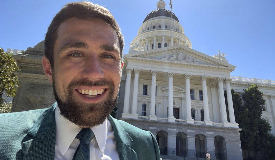 In a photo provided by Kevin Paffrath, Kevin Paffrath smiles for a selfie in front of the California State Capitol in Sacramento on Friday, July 16, 2021. The 29-year-old YouTuber is one of the Democrats running in the recall against California Gov. Gavin Newsom. Paffrath's videos typically touch on real estate and investment advice, and he's never held public office. (Kevin Paffrath via AP)