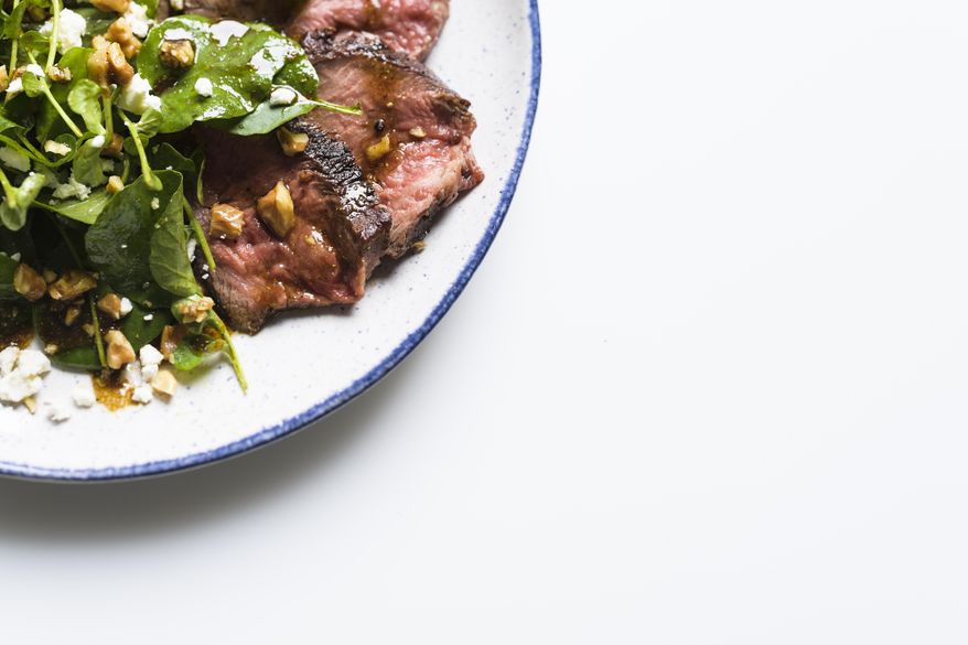 This image released by Milk Street shows a recipe for steak salad with walnuts and goat cheese. (Milk Street via AP)