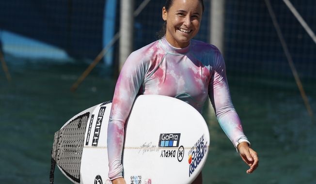 Surfer Johanne Defay, of France, leaves the water after a workout at Surf Ranch during practice rounds for the upcoming Olympics Tuesday, June 15, 2021, in Lemoore, Calif. Defay is headed to the Olympics for surfing&#x27;s debut at the Games, buoyed by an upset win against reigning world champion Carissa Moore, 28, at the high-intensity Surf Ranch competition last month. Though there&#x27;s much excitement and renewed enthusiasm for the women&#x27;s game, the objectification, pay disparities and opportunity gap have taken its toll. Industry leaders say they&#x27;re committed to righting the wrongs that have long held female surfers back in the male-dominated sport. The mental, financial and logistical roadblocks for women in surfing date back centuries. (AP Photo/Gary Kazanjian)