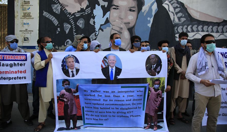 In this June 25, 2021 photo, Former Afghan interpreters hold placards during a demonstrations against the US government, in front of the US Embassy in Kabul, Afghanistan. The Biden administration says it will evacuate about 2,500 Afghans who worked for the U.S. government and their families to a military base in Virginia pending approval of their visas. The administration notified Congress on Monday that the Afghans will be housed at the Fort Lee Army base south of Richmond starting next week. (AP Photo/Mariam Zuhaib)