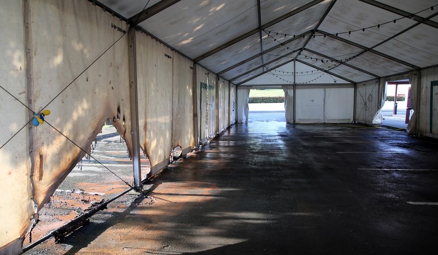 A view of the empty tent of a vaccination center after an arson attack on Saturday evening in Urrugne, southwestern France, Monday, July 19, 2021. Two COVID-19 vaccination centers were ransacked in less than 48 hours in France, over the weekend. (AP Photo/Bob Edme)
