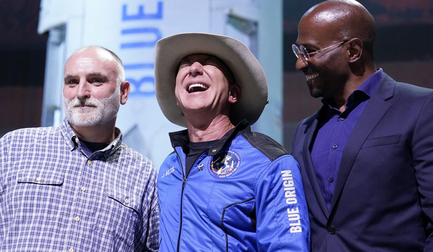 Jeff Bezos, center, founder of Amazon and space tourism company Blue Origin, poses for photos with Chef Jose Andres, left, and Van Jones, right, founder of Dream corps during a briefing following the launch of the New Shepard rocket from its spaceport near Van Horn, Texas, Tuesday, July 20, 2021. Andres and Jones were awarded Courage and Civility awards during the briefing. (AP Photo/Tony Gutierrez)