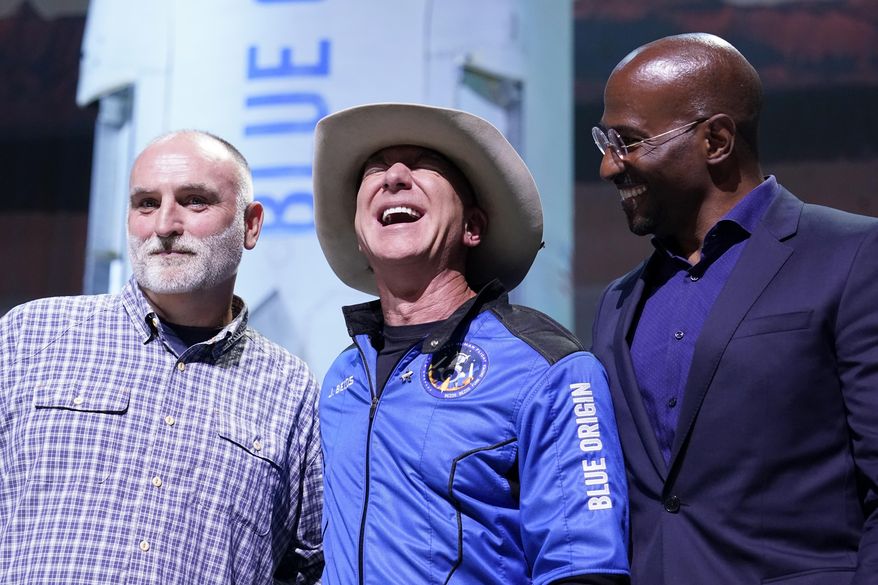 Jeff Bezos, center, founder of Amazon and space tourism company Blue Origin, poses for photos with Chef Jose Andres, left, and Van Jones, right, founder of Dream corps during a briefing following the launch of the New Shepard rocket from its spaceport near Van Horn, Texas, Tuesday, July 20, 2021. Andres and Jones were awarded Courage and Civility awards during the briefing. (AP Photo/Tony Gutierrez)