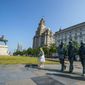 The Beatles statues and Royal Liver Building, center, on the waterfront area of Liverpool, which has been removed from the World Heritage List on Wednesday July 21, 2021.  The UN World Heritage Committee found developments including the new Everton soccer stadium threatened the value of the city&#39;s waterfront. (Peter Byrne/PA via AP)