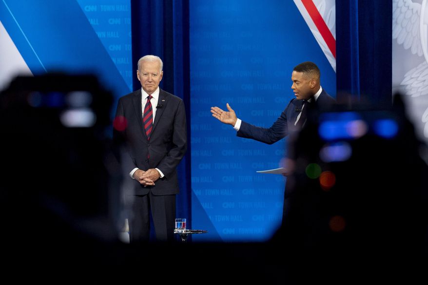 Cameras are visible in the foreground as President Joe Biden accompanied by CNN journalist Don Lemon, right, appears at a CNN town hall at Mount St. Joseph University in Cincinnati, Wednesday, July 21, 2021. (AP Photo/Andrew Harnik)