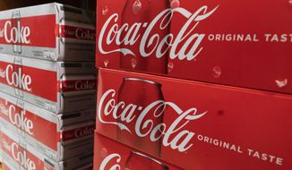 Cases of Coca-Cola are displayed in a supermarket, Monday, April 5, 2021, in New York. (AP Photo/Mark Lennihan) ** FILE **