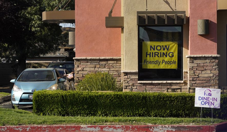 A hiring sign hangs in the window of a Taco Bell in Sacramento, Calif., Thursday, July 15, 2021. (AP Photo/Rich Pedroncelli))