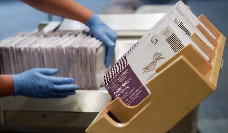 In this Nov. 1, 2020, file photo, envelopes containing ballots are shown at a San Francisco Department of Elections at a voting center in San Francisco. Californians will start receiving ballots next month asking if Gov. Gavin Newsom, a Democrat should be recalled and if so, who they want to vote for to replace him. (AP Photo/Jeff Chiu, File)