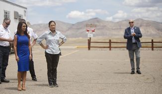 Interior Secretary Deb Haaland, right, stands with U.S. Rep. Lauren Boebert, R-Colo., while touring the Grand Junction Air Center complex, a multi-purpose wildland fire management and operation center, Friday, July 23, 2021, in Grand Junction, Colo. (McKenzie Lange/The Grand Junction Daily Sentinel via AP)