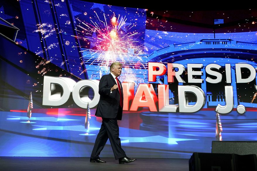 Former President Donald Trump arrives on stage prior to speaking to supporters at a Turning Point Action gathering, Saturday, July 24, 2021, in Phoenix. (AP Photo/Ross D. Franklin)