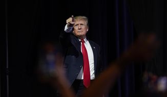 Former President Donald Trump points to supporters after speaking at a Turning Point Action gathering in Phoenix on Saturday, July 24, 2021. (AP Photo/Ross D. Franklin) **FILE**