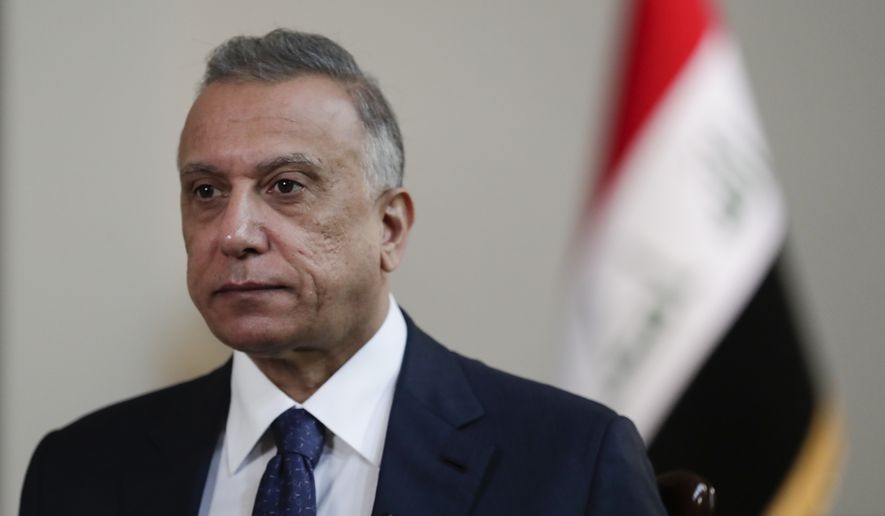 Iraqi Prime Minister Mustafa al-Kadhimi poses in his office during an interview with The Associated Press in Baghdad, Iraq, Friday, July 23, 2021. (AP Photo/Khalid Mohammed)